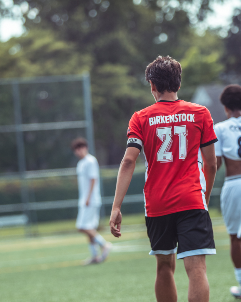 Maxime wearing the #21 captain's jersey on the pitch