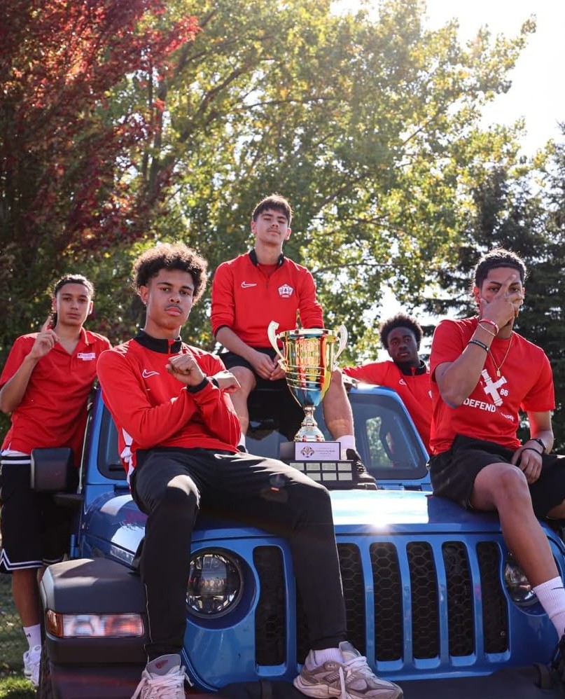 Maxime with teammates and the championship trophy